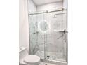 Bathroom with marble shower and frameless glass enclosure at 8296 Portofino Dr # 102, Davenport, FL 33896