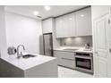 Modern kitchen with white cabinets and quartz countertops at 8296 Portofino Dr # 102, Davenport, FL 33896