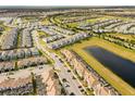 Large community view showcasing numerous townhomes and green spaces at 8985 Stinger Dr, Davenport, FL 33896