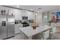 Modern kitchen with stainless steel appliances and white cabinets at 1254 Wispy Cypress Dr, Kissimmee, FL 34746