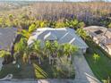 One-story house with a grey roof, surrounded by palm trees at 135 Lemon Grove Dr, Poinciana, FL 34759