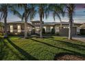 Tan house with palm trees and a two-car garage at 135 Lemon Grove Dr, Poinciana, FL 34759