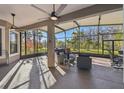 Spacious screened-in porch with comfortable seating and a view of the backyard at 135 Lemon Grove Dr, Poinciana, FL 34759