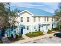 Aerial view of townhouses with blue roofs, light-colored siding, and landscaped grounds at 2015 Grand Oak Dr, Kissimmee, FL 34744
