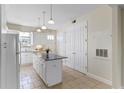 Kitchen with white cabinets, granite island, and stainless steel appliances at 2015 Grand Oak Dr, Kissimmee, FL 34744