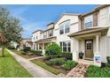 Townhomes with manicured lawns and a sidewalk at 2603 Amati Dr, Kissimmee, FL 34741