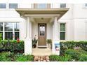 Townhome entrance with a covered porch and brick walkway at 2603 Amati Dr, Kissimmee, FL 34741
