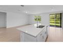 Open kitchen with a large island and access to the backyard at 3142 Viceroy Ct, Poinciana, FL 34759