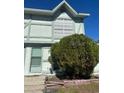 Front view of a light green two-story townhouse at 3209 Windover Ave, Kissimmee, FL 34741