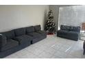 Living room with gray sectional sofa and a Christmas tree at 3209 Windover Ave, Kissimmee, FL 34741