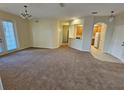Spacious living room with carpet and kitchen views at 3341 Whitestone Cir # 205, Kissimmee, FL 34741