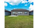 Large backyard with ample green space, a small patio, and an open view, perfect for entertaining and relaxation at 446 Citrus Isle Loop, Davenport, FL 33837