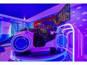 Themed bedroom with a ride-on toy and large screen at 4575 Narrative Ln, Kissimmee, FL 34746