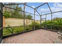 Screened patio with brick pavers and lush greenery at 940 Grand Canal Dr, Poinciana, FL 34759