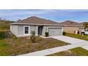Newly built one-story house featuring a two-car garage and well-maintained lawn at 1067 Haines Dr, Winter Haven, FL 33881