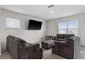 Living room with grey sofas and large TV at 113 Eagleview Loop, Davenport, FL 33837