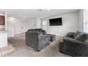 Living room with grey couches and access to kitchen at 113 Eagleview Loop, Davenport, FL 33837