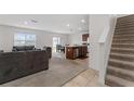 Spacious living room with grey sofas and view of kitchen at 113 Eagleview Loop, Davenport, FL 33837