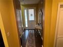 Bright entryway with dark hardwood floors and decorative mirror at 1427 Pacific Rd, Kissimmee, FL 34759