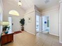 Bright and airy foyer with tile floors and access to other rooms at 154 Robin Rd, Davenport, FL 33896