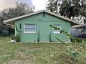 Newly painted green house with well-manicured lawn at 1808 S Mulberry Ave, Sanford, FL 32771