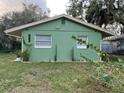 Newly painted green house with well-manicured lawn at 1808 S Mulberry Ave, Sanford, FL 32771