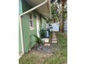 Side yard with green house exterior, landscaping, and walkway at 1808 S Mulberry Ave, Sanford, FL 32771