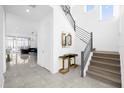 Bright entryway with modern staircase and tile floors at 2137 Pine Oak Loop, Davenport, FL 33837