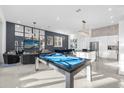 Open concept kitchen with island, stainless steel appliances, and pool table at 2137 Pine Oak Loop, Davenport, FL 33837