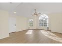 Bright living room with laminate floors and arched window at 2317 Prime Cir # B, Kissimmee, FL 34746