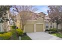 Side view of a two-story home with a well-manicured lawn and a two-car garage at 2615 Pawnall St, Kissimmee, FL 34747