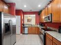 Spacious kitchen featuring stainless steel appliances, granite countertops, and ample cabinet space at 2615 Pawnall St, Kissimmee, FL 34747