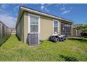 Exterior view of a backyard with an air conditioning unit and off-road vehicle at 2820 Avian Loop, Kissimmee, FL 34741