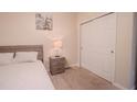 Neutral bedroom featuring carpeted floors and a wardrobe with white sliding doors at 2820 Avian Loop, Kissimmee, FL 34741