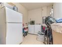 Functional laundry room with modern appliances, ample storage, and tiled flooring at 2820 Avian Loop, Kissimmee, FL 34741