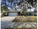 Single-story house with gray brick facade and a white garage door at 31 Augusta Cir, St Cloud, FL 34769