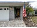 Front porch with gray brick columns and American flag at 31 Augusta Cir, St Cloud, FL 34769