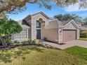 Two-story house with landscaping and a brick walkway at 336 Del Sol Ave, Davenport, FL 33837