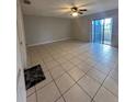 Spacious living room with tile floors and sliding glass doors leading to a patio at 520 Carlsbad Dr, Kissimmee, FL 34758