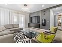 Modern living room with sectional sofa, glass coffee table, and stylish decor at 7617 Wilmington Loop, Kissimmee, FL 34747