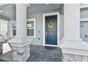 Elegant front entry with dark blue door and sunflower wreath at 8870 Backspin Ln, Champions Gate, FL 33896