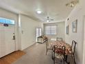 Combined living and dining area with light carpet and white furniture at 4006 San Gallo Dr # 108, Kissimmee, FL 34741