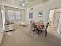 Combined living and dining area with light carpet and white furniture at 4006 San Gallo Dr # 108, Kissimmee, FL 34741