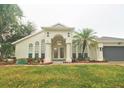 Front view of a house with double doors and landscaping at 10001 Newington Dr, Orlando, FL 32836