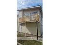 Two-story building with a balcony, tan siding, and a walkway leading to the entrance at 1022 Spring Meadow Dr # 1022, Kissimmee, FL 34741