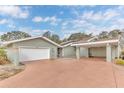 House exterior showcasing a light green color scheme and a two-car garage at 109 Arrowhead Ln, Haines City, FL 33844