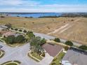 Aerial view showing house, neighborhood, and lake at 125 Viola Dr, Auburndale, FL 33823