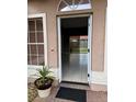 Welcoming entryway with neutral colors, ceramic tile floors, and a view of the backyard through sliding glass doors at 149 Birmingham Dr, Kissimmee, FL 34758