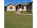 House exterior showcasing a well-maintained lawn and walkway at 149 Birmingham Dr, Kissimmee, FL 34758