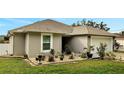 One-story house with nicely landscaped front yard and a white fence at 203 North Cir, Davenport, FL 33837